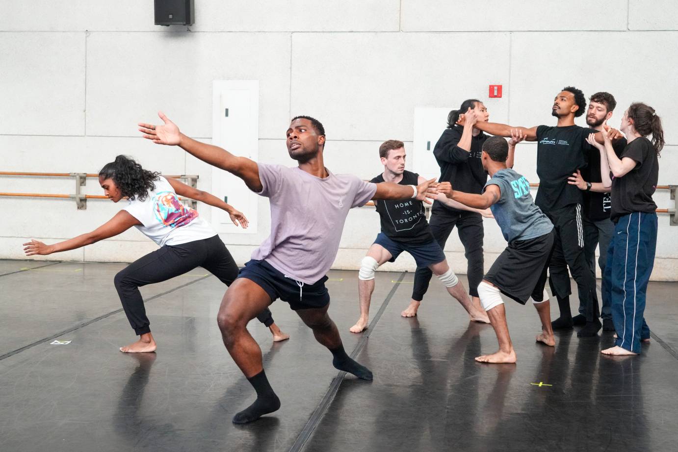 the dancers form a large sculptural shape which is the preparation for the leader to be lifted majestically above them and then float is if walking on air or water