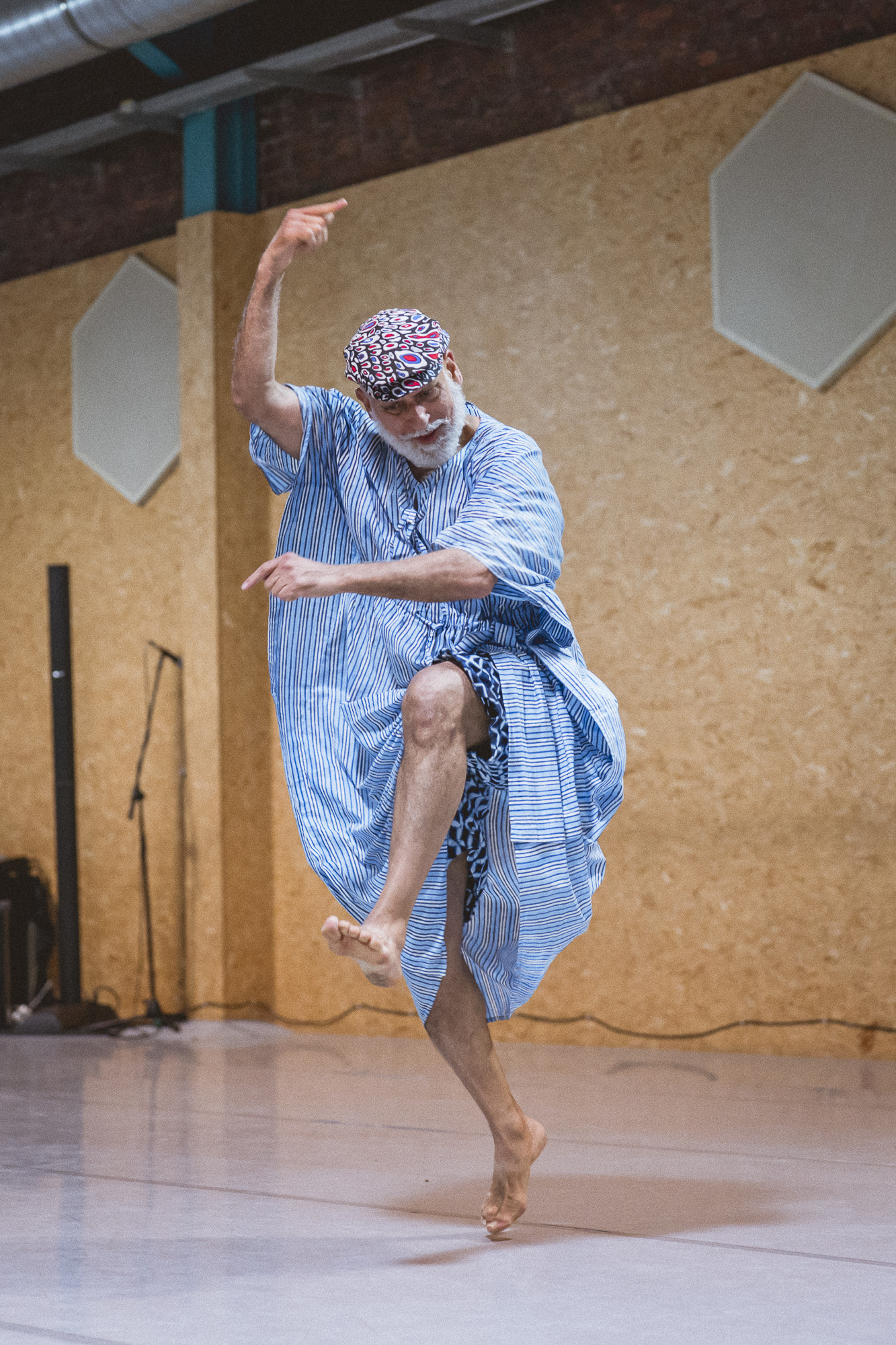 David Zambrano dances impishly in a blue and white striped caftan